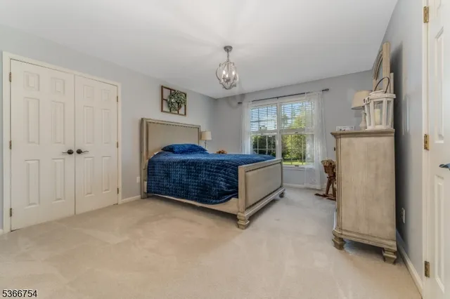 a spacious bedroom with a bed and a window