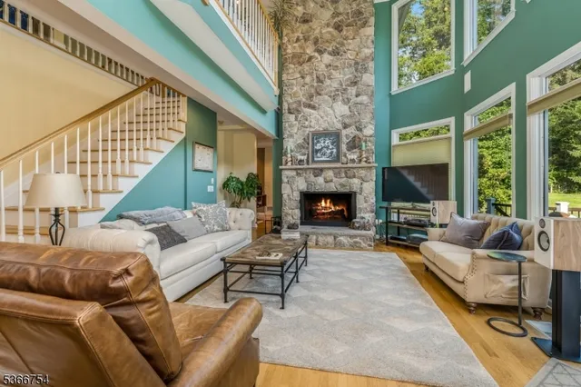 a living room with furniture fireplace and a large window