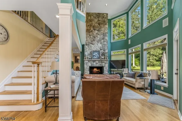 a living room with furniture a fireplace and a large window