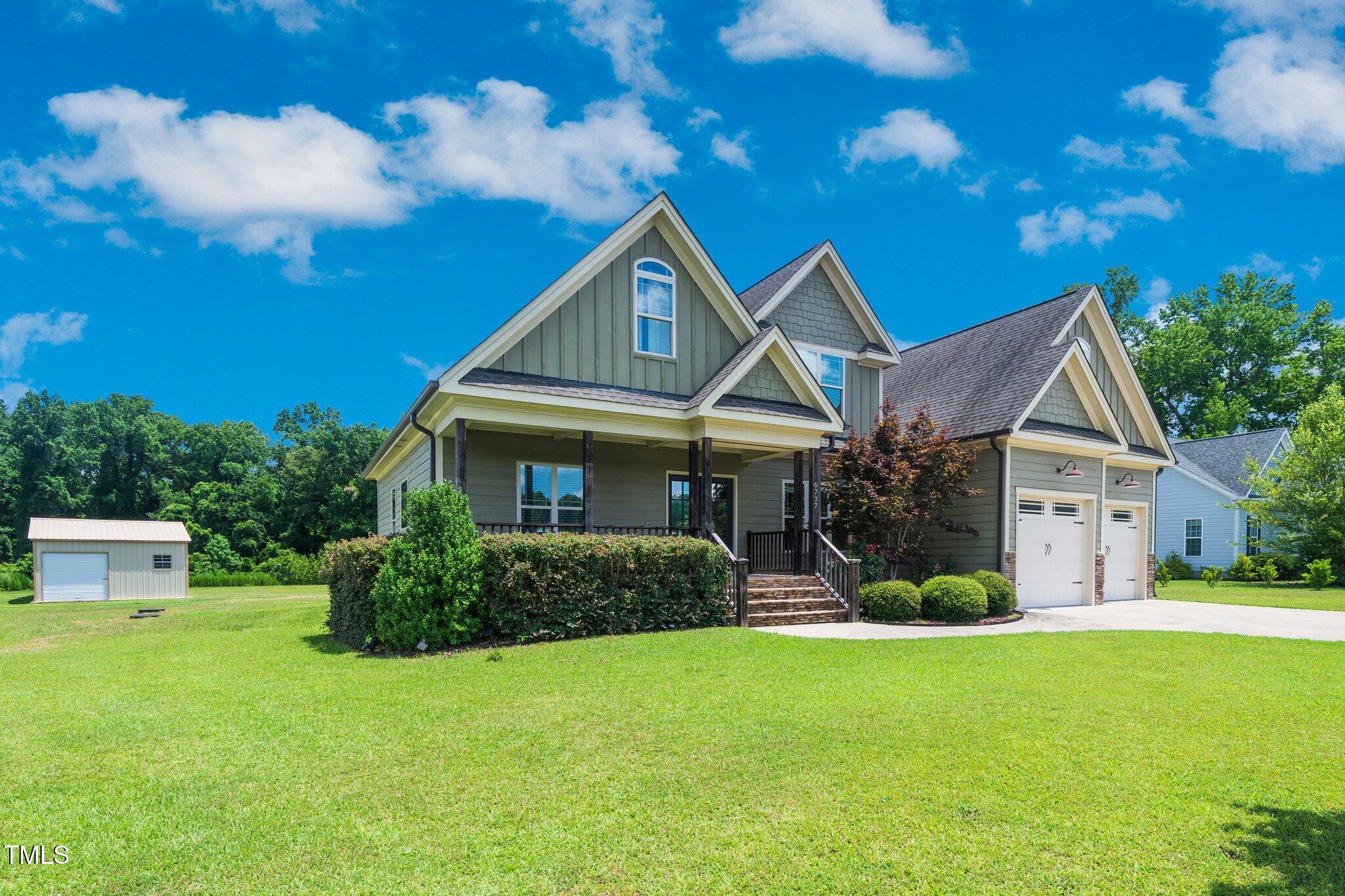 6737 Dwight Rowland Road Willow Spring, NC 27592 - Photo 1 of 50 a front view of a house with a yard