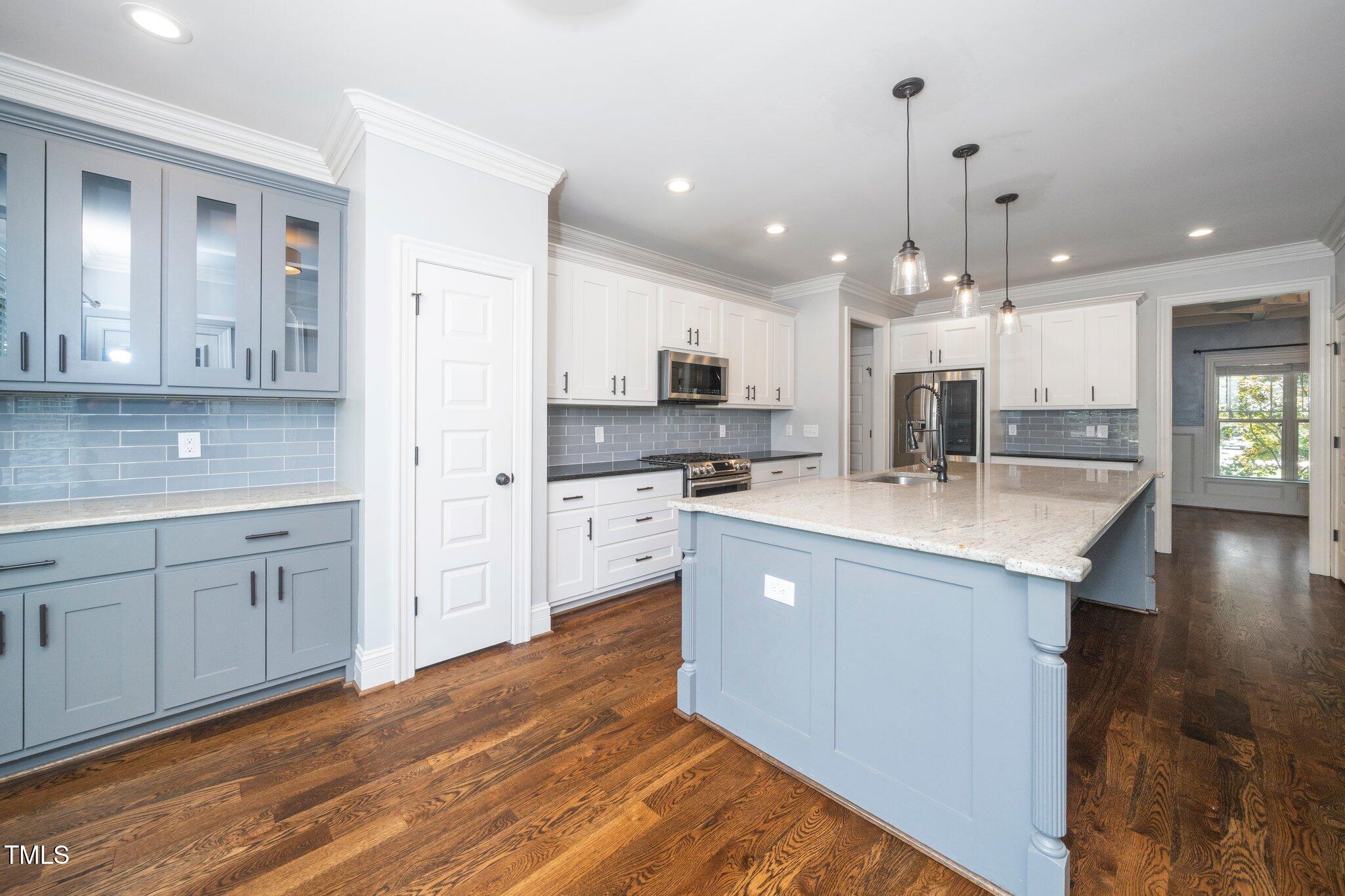 6737 Dwight Rowland Road Willow Spring, NC 27592 - Photo 15 of 50 a large kitchen with kitchen island a sink stainless steel appliances and cabinets
