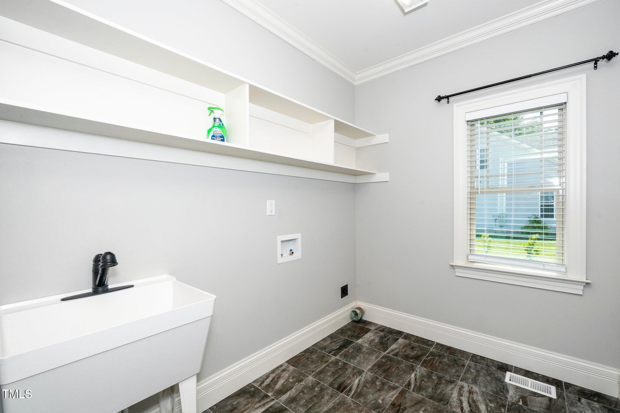 6737 Dwight Rowland Road Willow Spring, NC 27592 - Photo 21 of 50 a view of a room that has a window and a sink