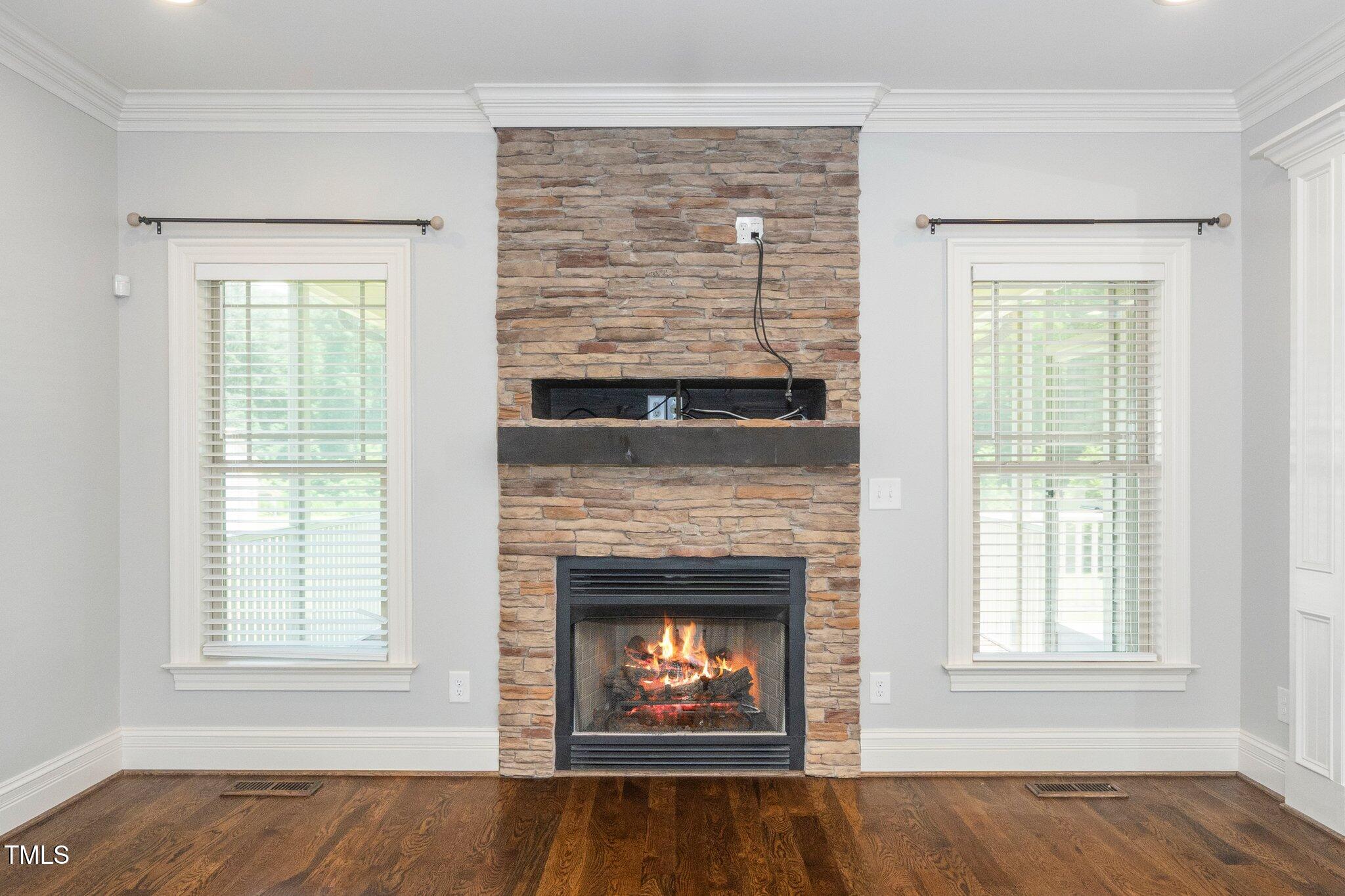 6737 Dwight Rowland Road Willow Spring, NC 27592 - Photo 24 of 50 an empty room with windows and fireplace