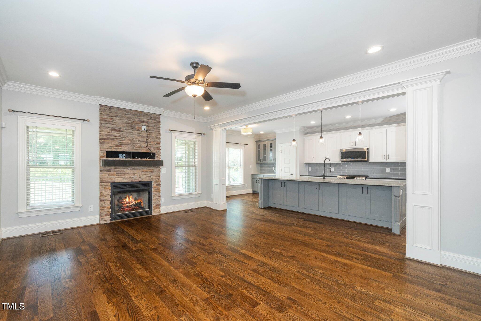 6737 Dwight Rowland Road Willow Spring, NC 27592 - Photo 25 of 50 a large kitchen with granite countertop a stove cabinets and wooden floor