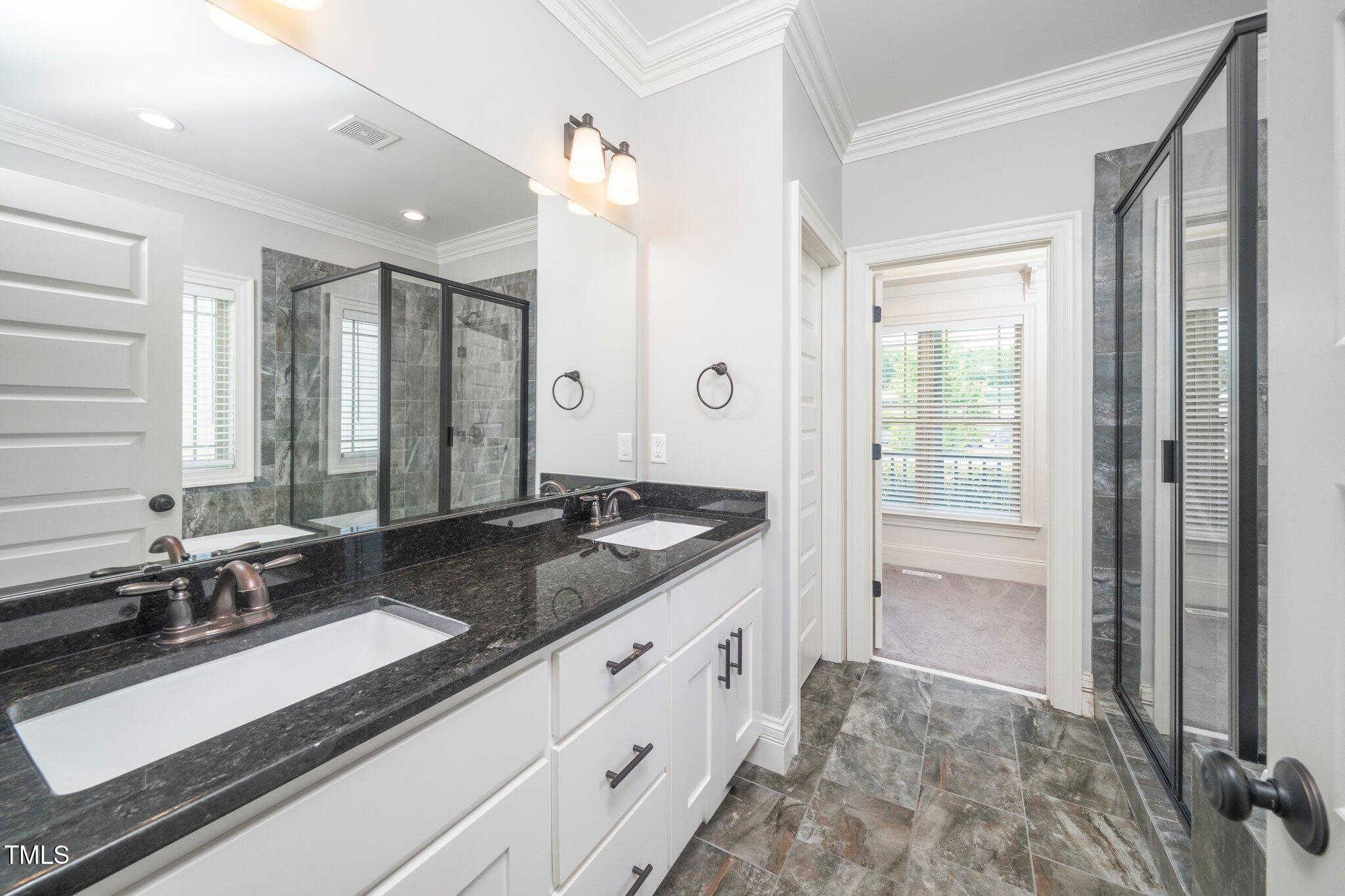 6737 Dwight Rowland Road Willow Spring, NC 27592 - Photo 28 of 50 a bathroom with a granite countertop sink and a mirror