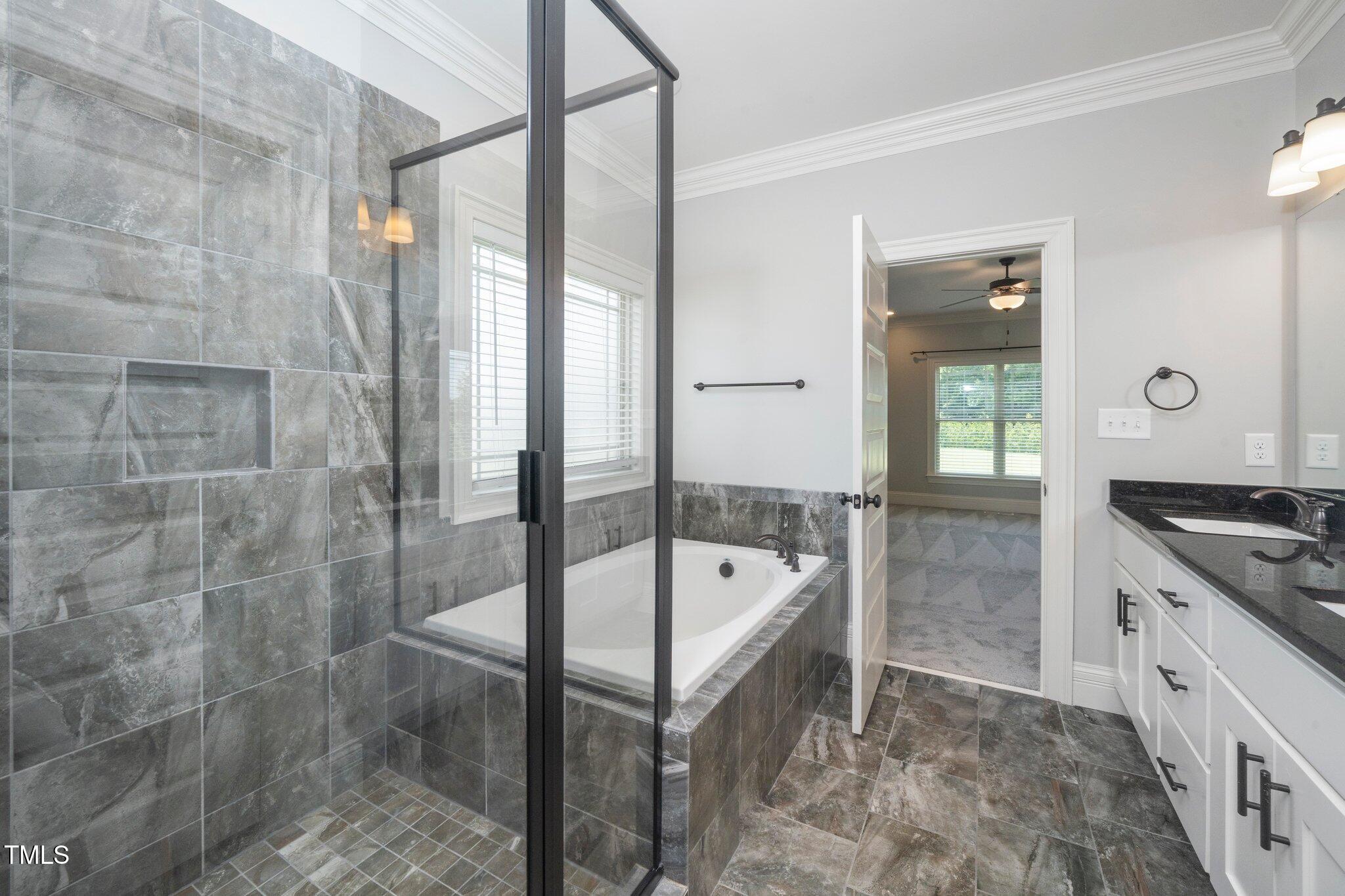 6737 Dwight Rowland Road Willow Spring, NC 27592 - Photo 29 of 50 a bathroom with a tub sink and mirror