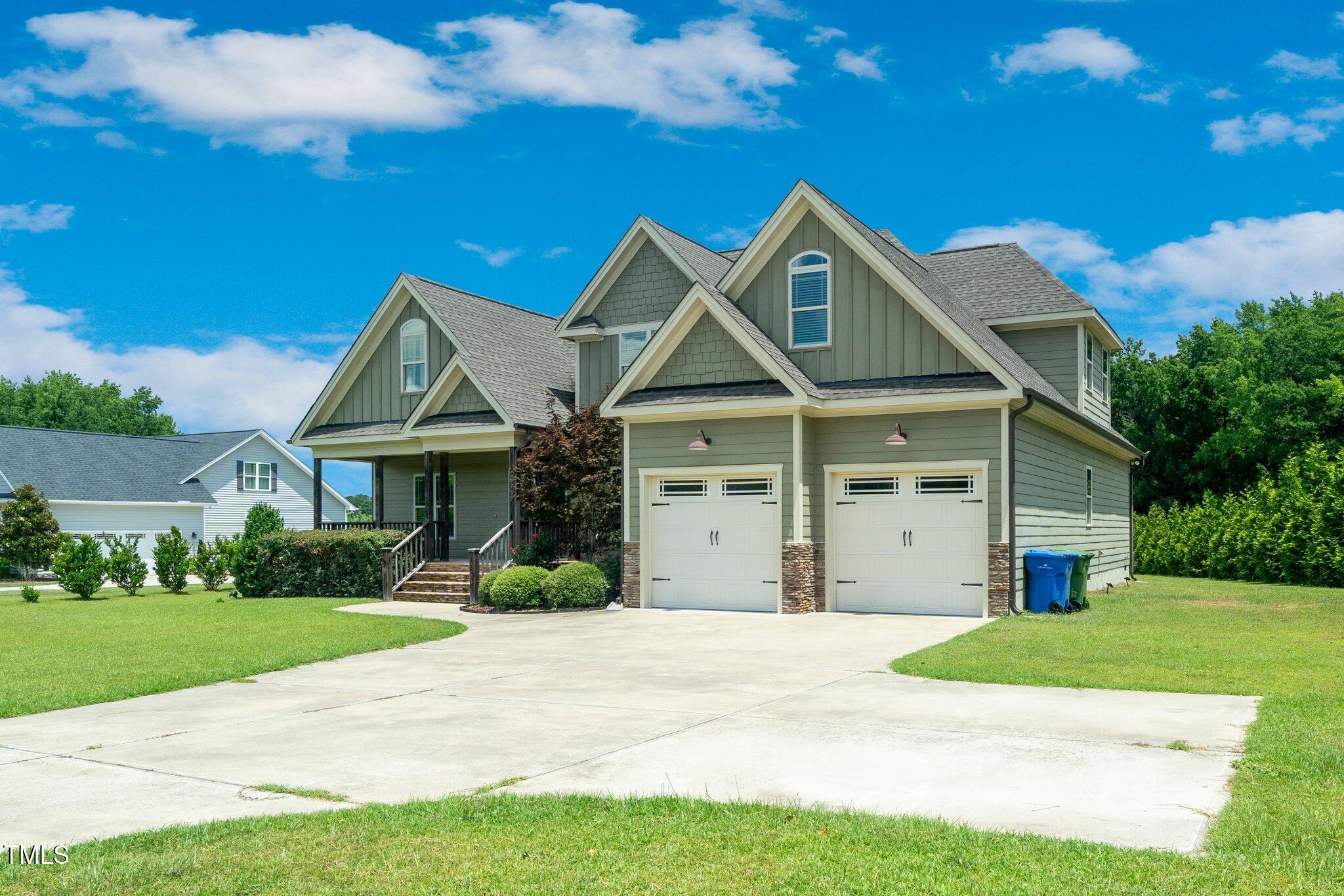 6737 Dwight Rowland Road Willow Spring, NC 27592 - Photo 3 of 50 a front view of a house with yard and garage