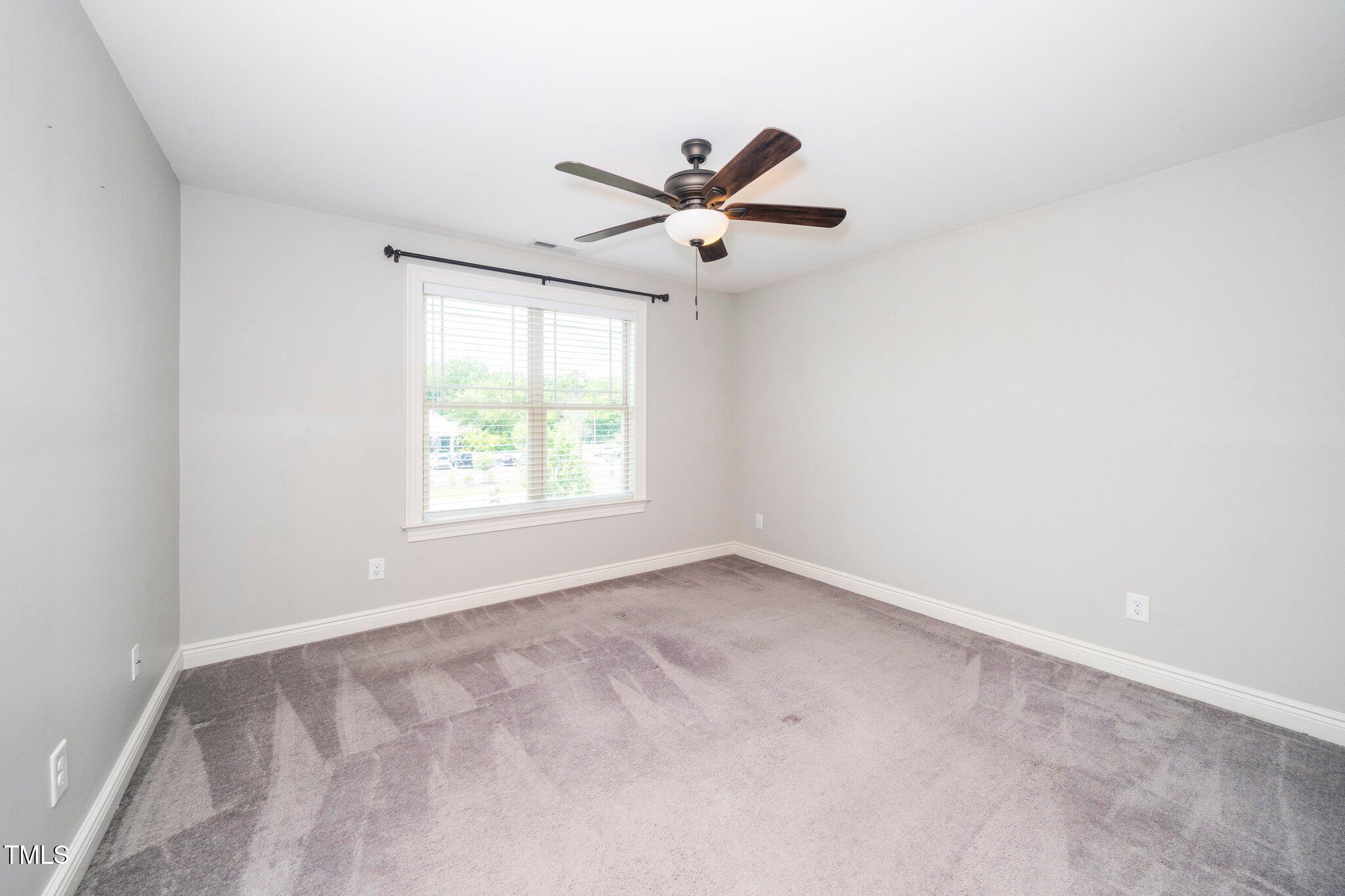 6737 Dwight Rowland Road Willow Spring, NC 27592 - Photo 35 of 50 a view of an empty room with a window