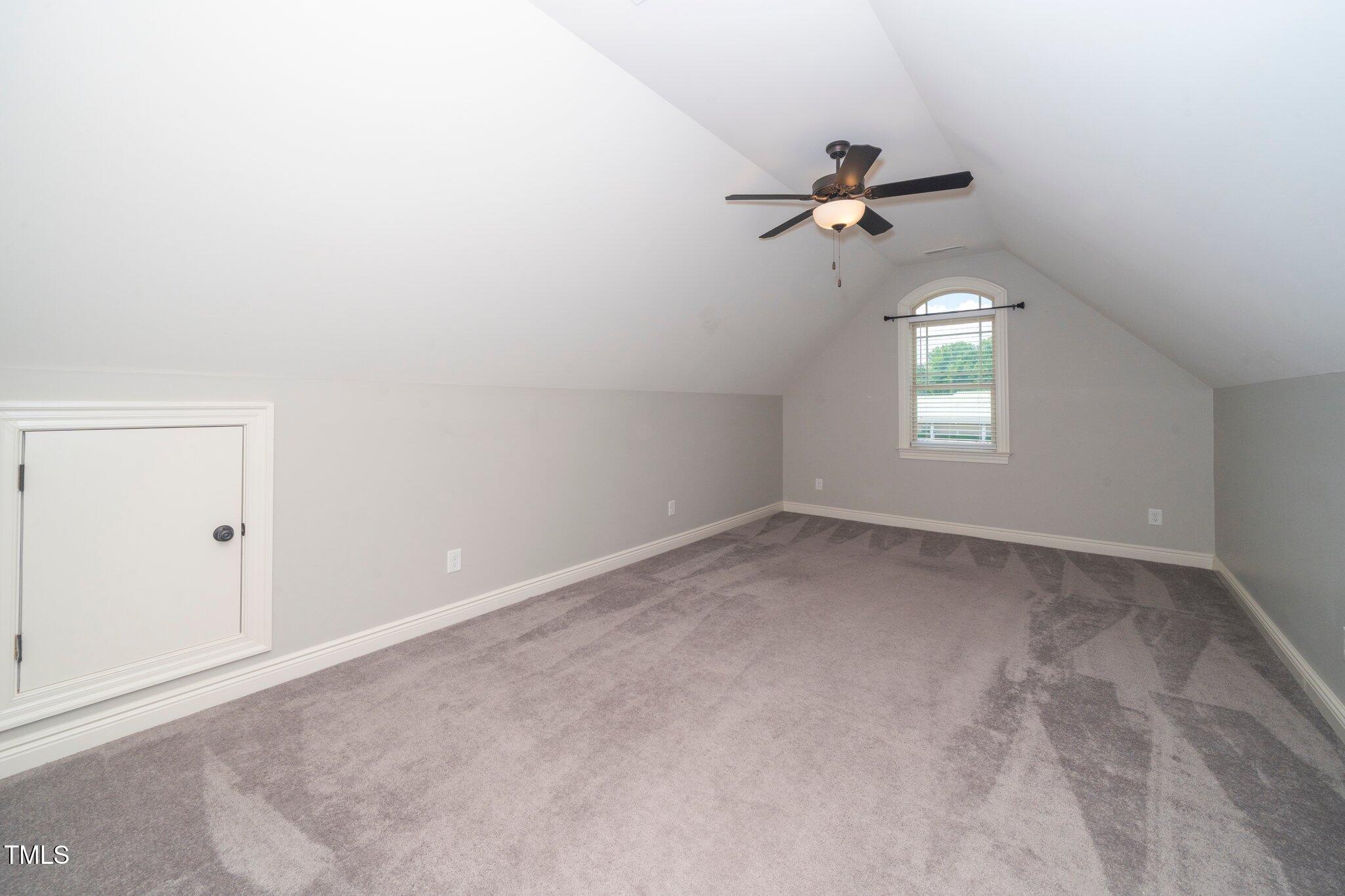 6737 Dwight Rowland Road Willow Spring, NC 27592 - Photo 37 of 50 an empty room with windows and fan