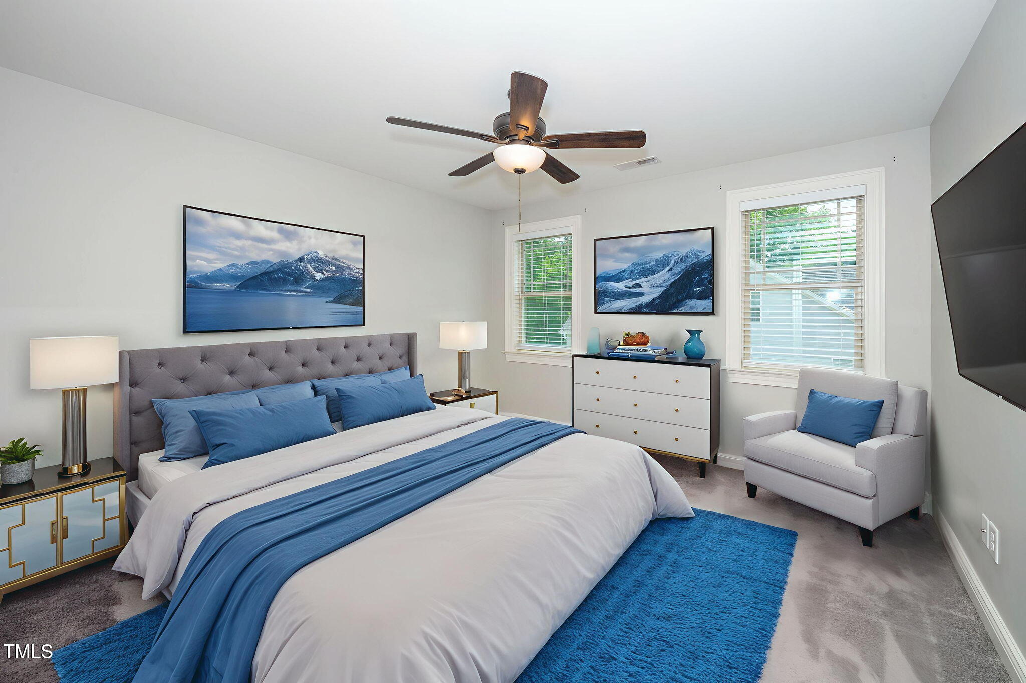 6737 Dwight Rowland Road Willow Spring, NC 27592 - Photo 38 of 50 a bedroom with a bed a couch and a flat screen tv