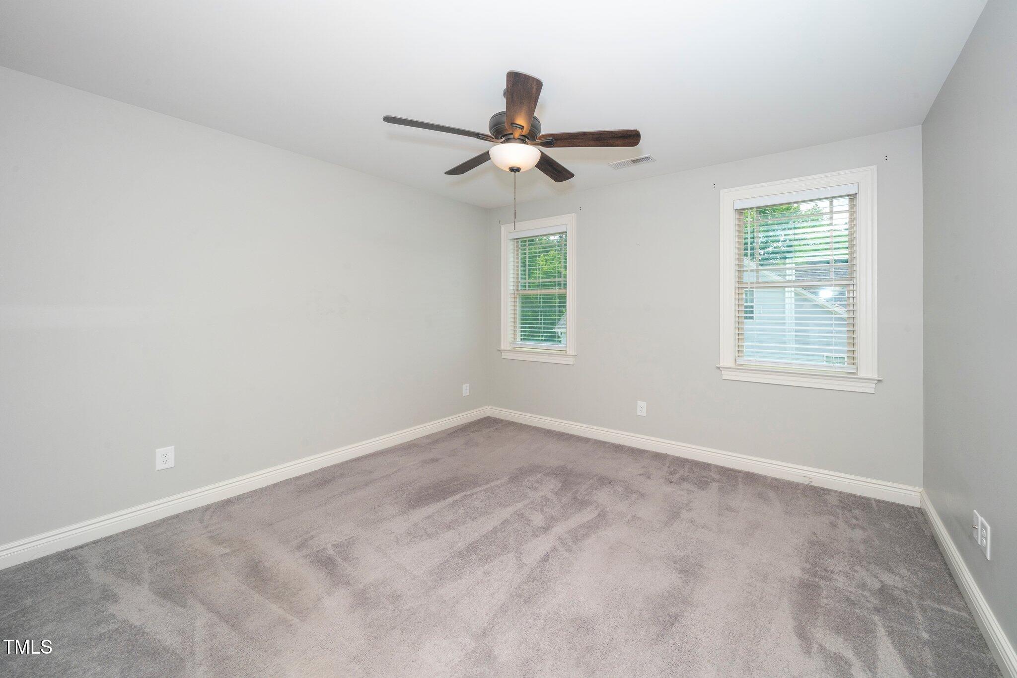 6737 Dwight Rowland Road Willow Spring, NC 27592 - Photo 39 of 50 an empty room with windows and fan