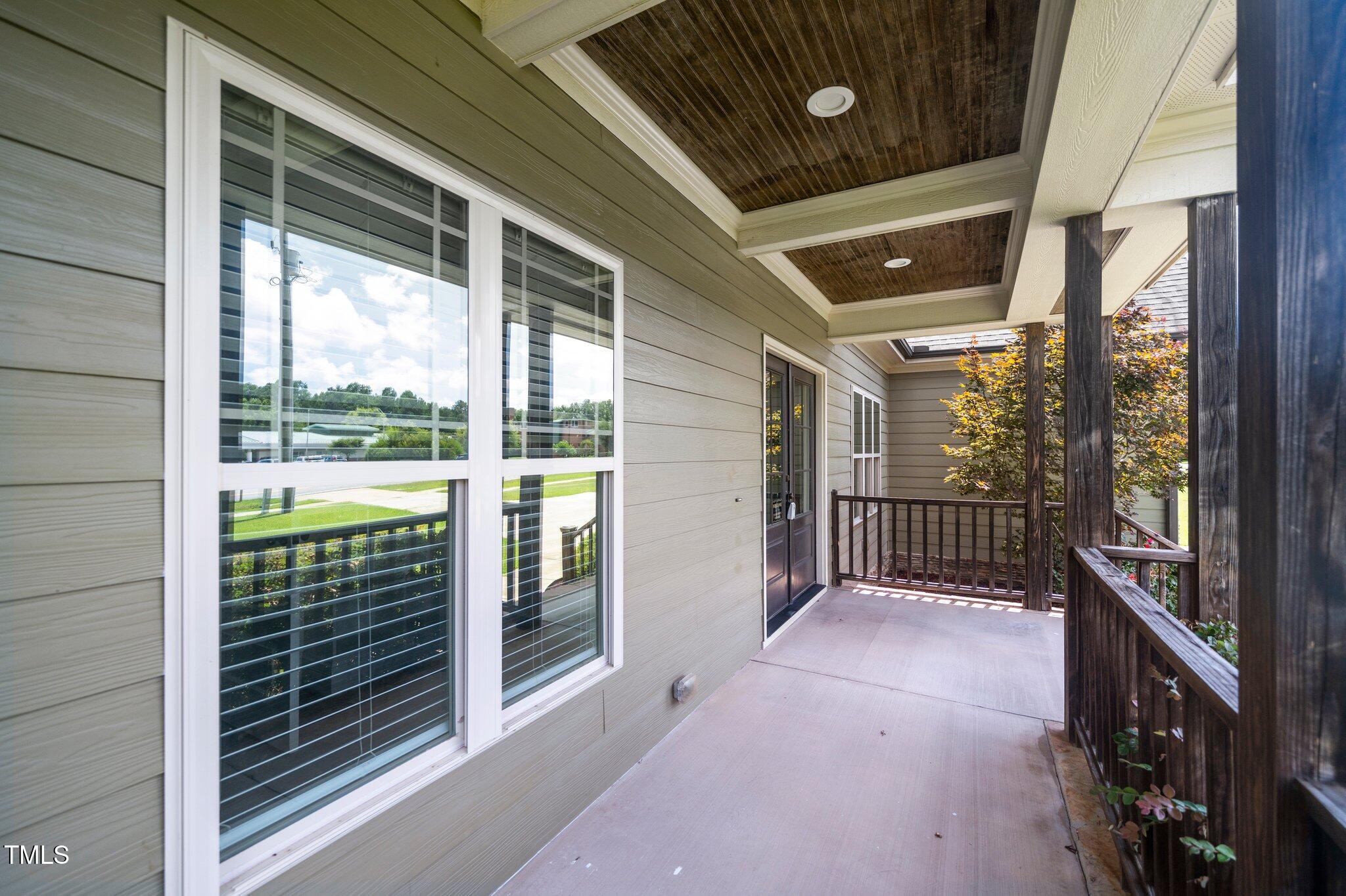 6737 Dwight Rowland Road Willow Spring, NC 27592 - Photo 4 of 50 a view of a porch with wooden floor