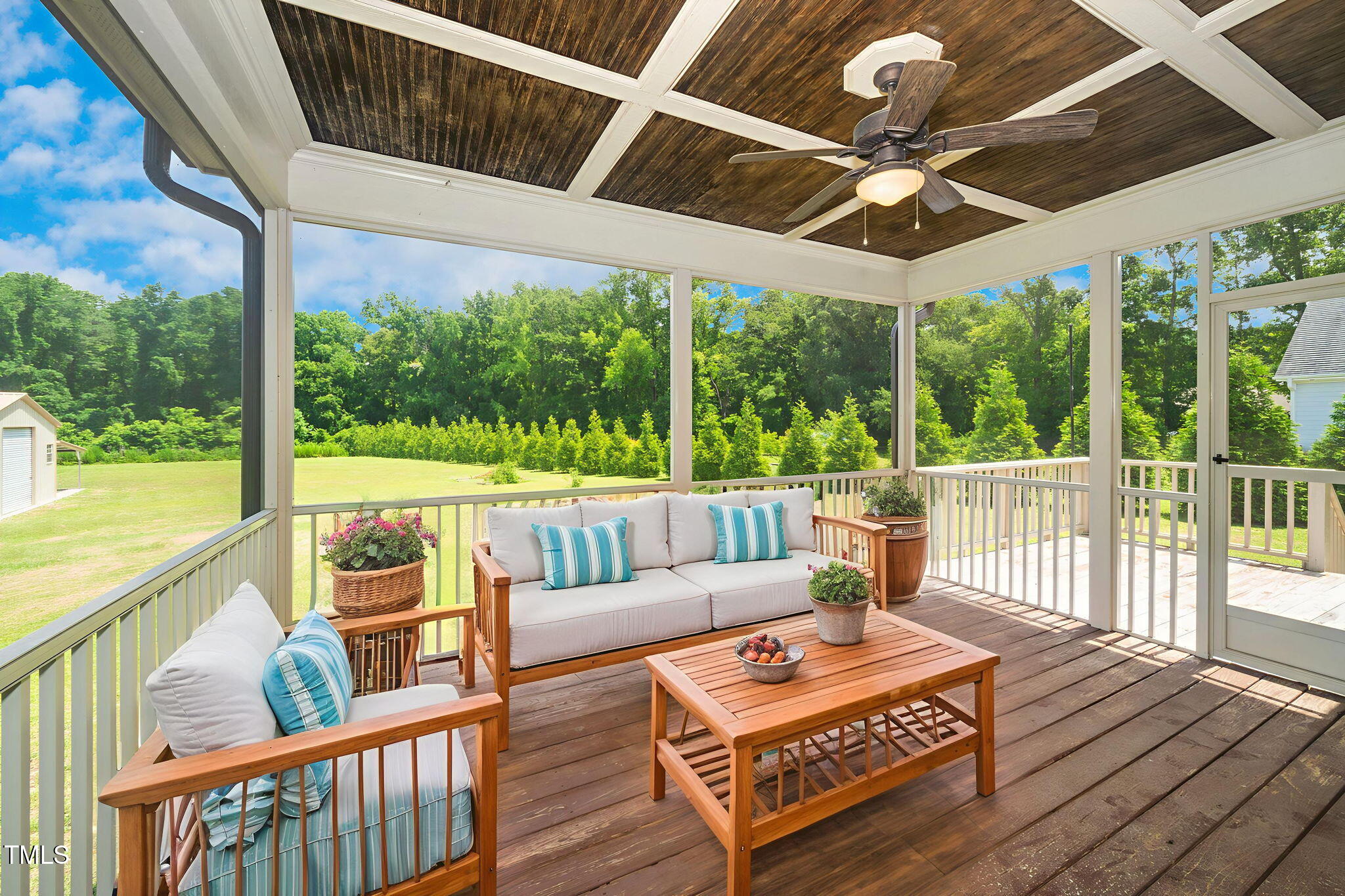 6737 Dwight Rowland Road Willow Spring, NC 27592 - Photo 41 of 50 a view of a patio with couches chairs and wooden floor