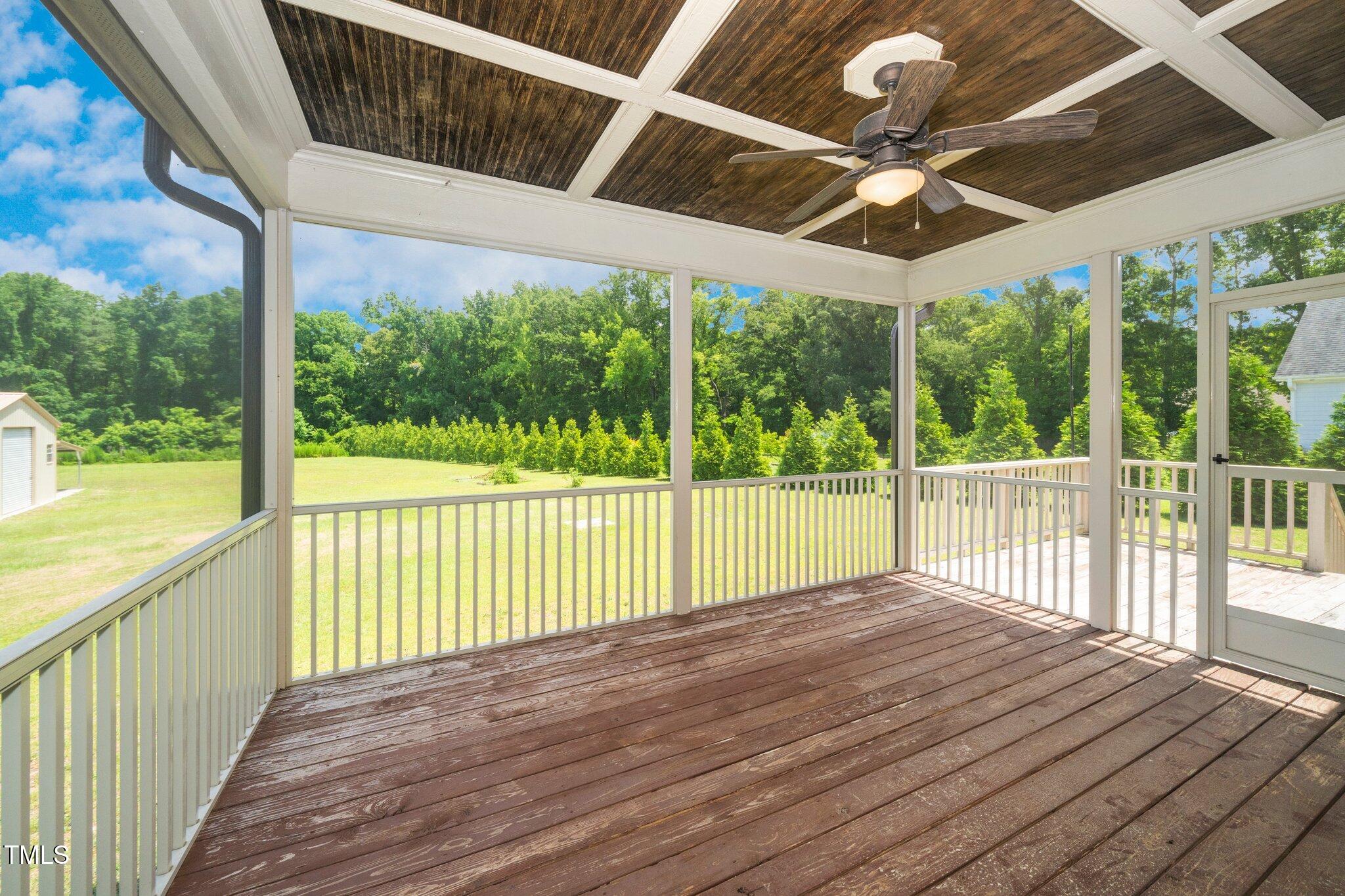 6737 Dwight Rowland Road Willow Spring, NC 27592 - Photo 42 of 50 a view of a deck with wooden floor and roof with a garden view