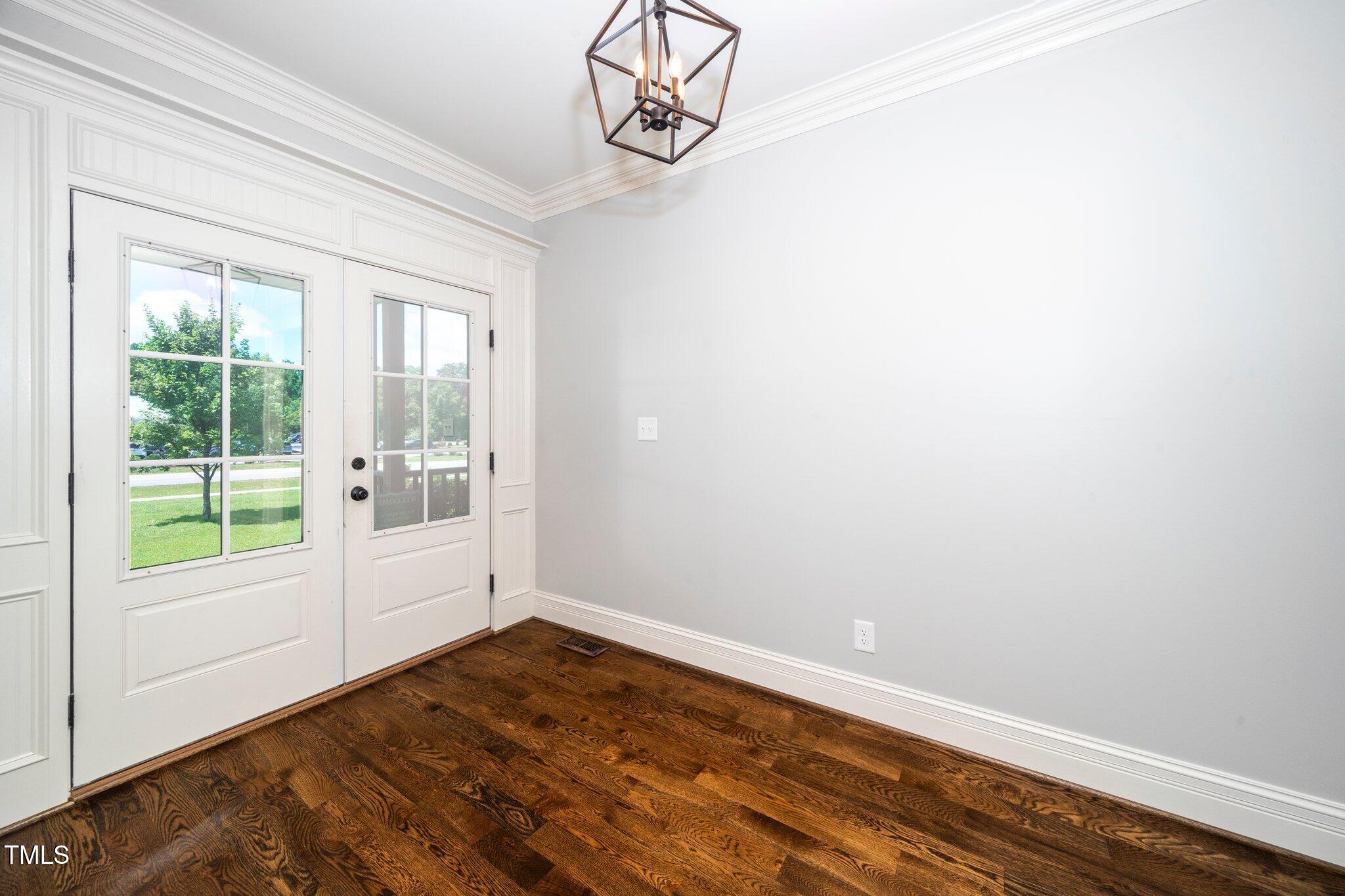 6737 Dwight Rowland Road Willow Spring, NC 27592 - Photo 6 of 50 a view of a room with wooden floor and windows