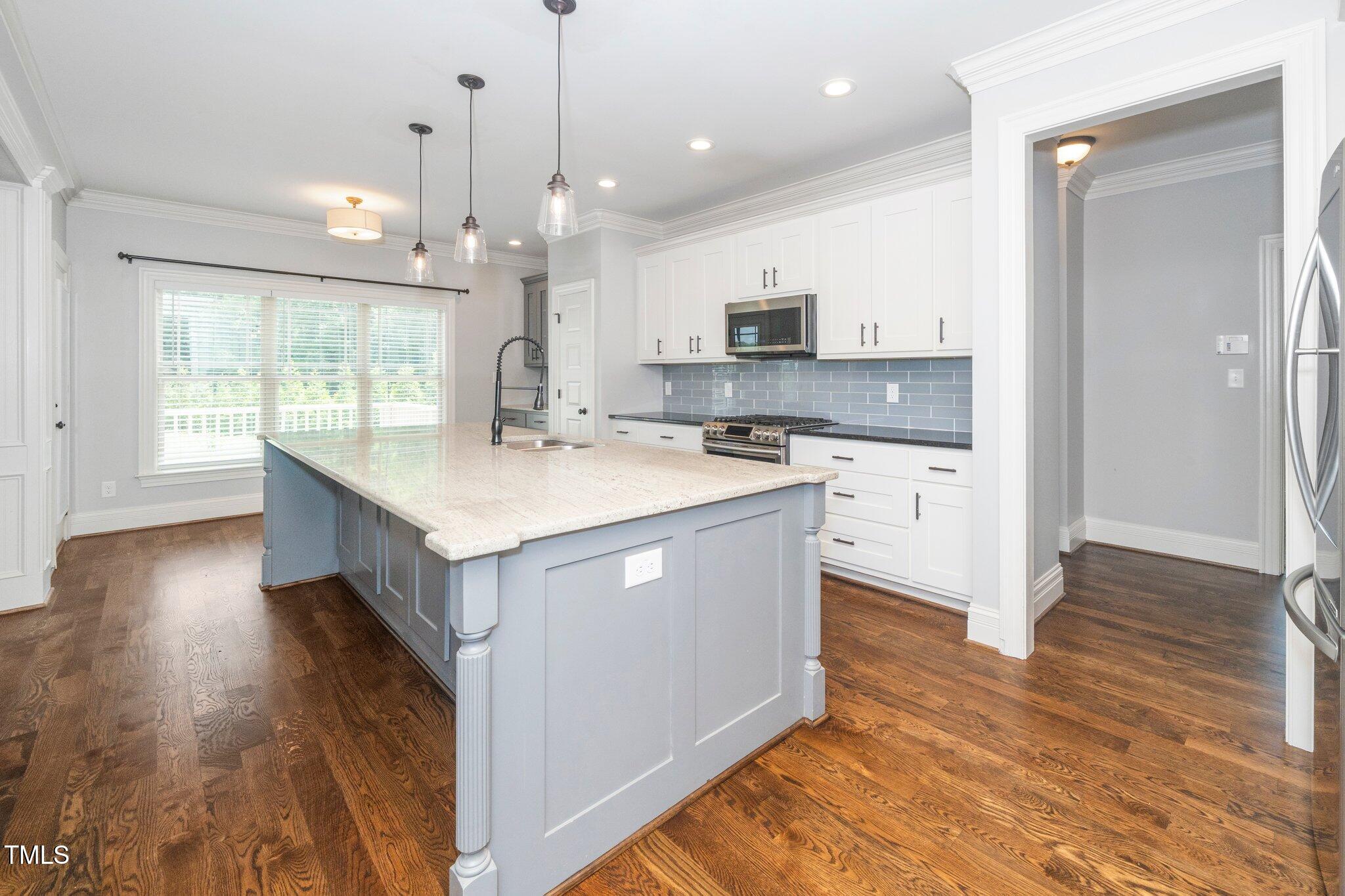 6737 Dwight Rowland Road Willow Spring, NC 27592 - Photo 9 of 50 a kitchen with a sink stove and wooden floor