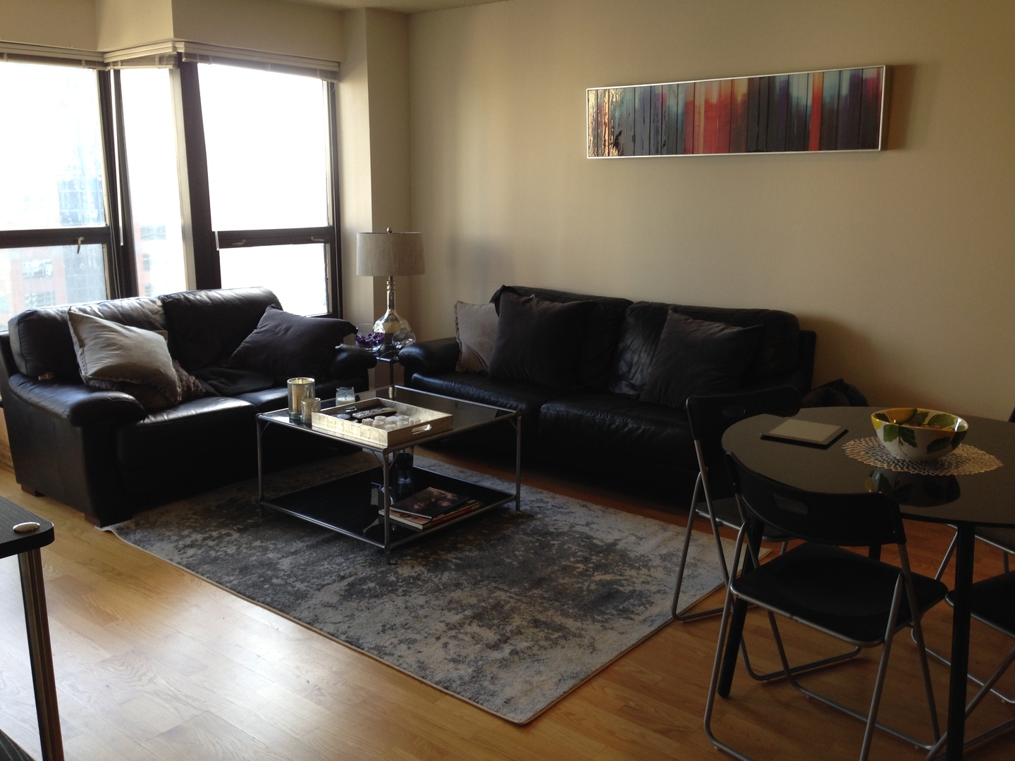 30 East Huron Street, Unit 3901 Chicago, IL 60611 - Photo 2 of 13 a living room with furniture wooden floor and a table