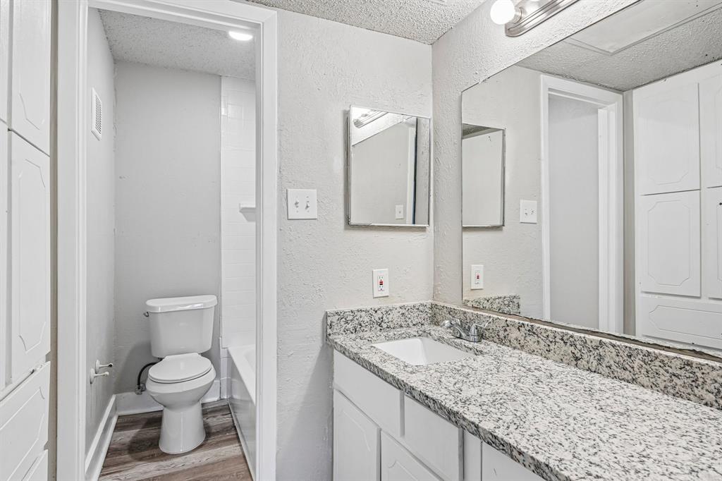 5534 Boca Raton Boulevard, Unit 292 Fort Worth, TX 76112 - Photo 21 of 31 a bathroom with a granite countertop sink toilet and shower