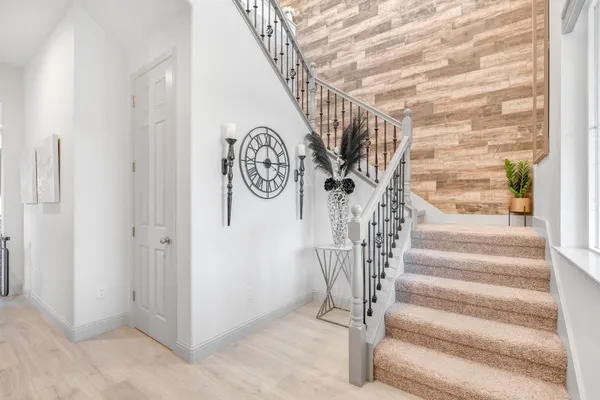 a kitchen with stainless steel appliances refrigerator dining table and chairs