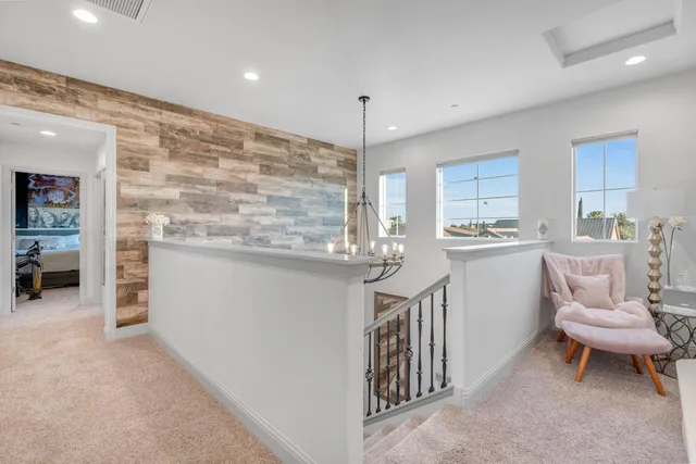 a bedroom with bed couches and flat tv screen