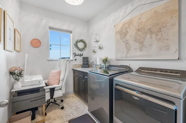 a bedroom with a bed a couch and a chandelier