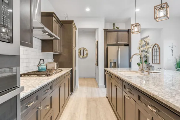 a kitchen with sink and refrigerator