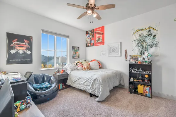 a bedroom with a bed and a chandelier