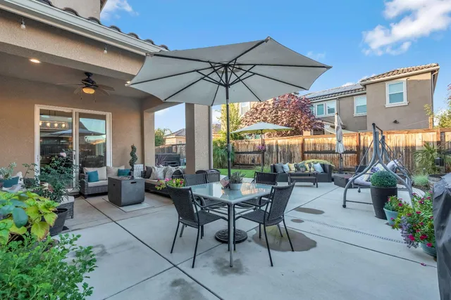 a view of a patio with couches and potted plants