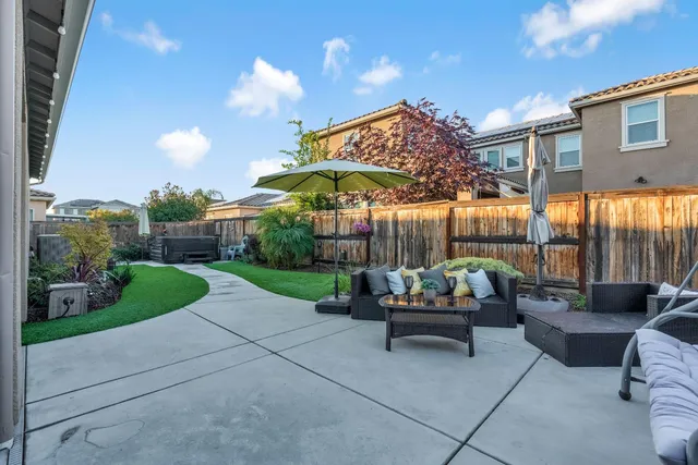 a view of a house with backyard porch and sitting area