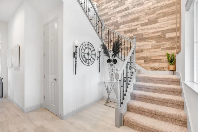 a kitchen with stainless steel appliances refrigerator dining table and chairs