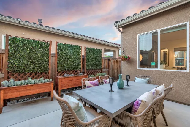 a view of a patio with a dining table and chairs
