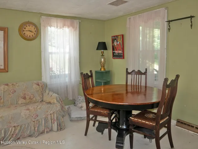 a view of a dining room with furniture and a window