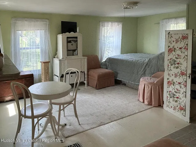 a bedroom with furniture and a window