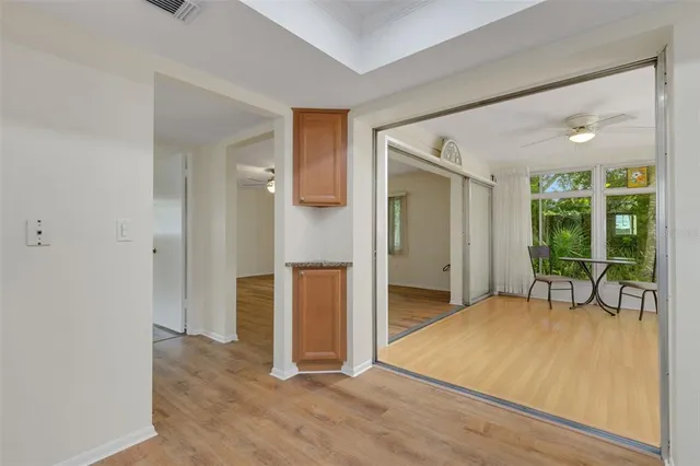 a view of a livingroom with wooden floor and a bathroom