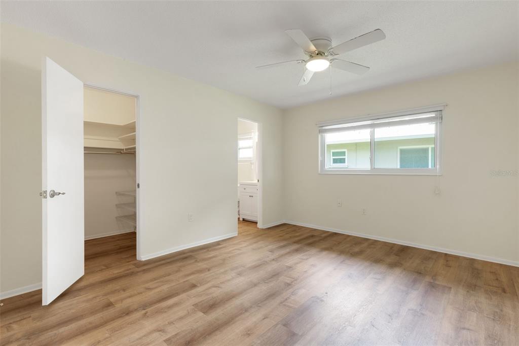 66 Strathmore Boulevard Sarasota, FL 34233 - Photo 16 of 39 an empty room with wooden floor ceiling fan and windows