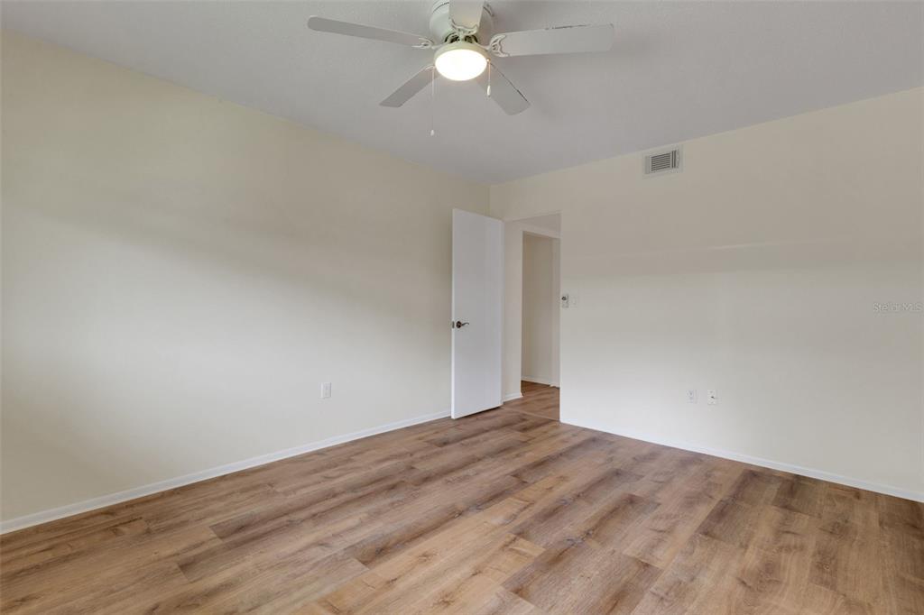 66 Strathmore Boulevard Sarasota, FL 34233 - Photo 18 of 39 a view of empty room with wooden floor