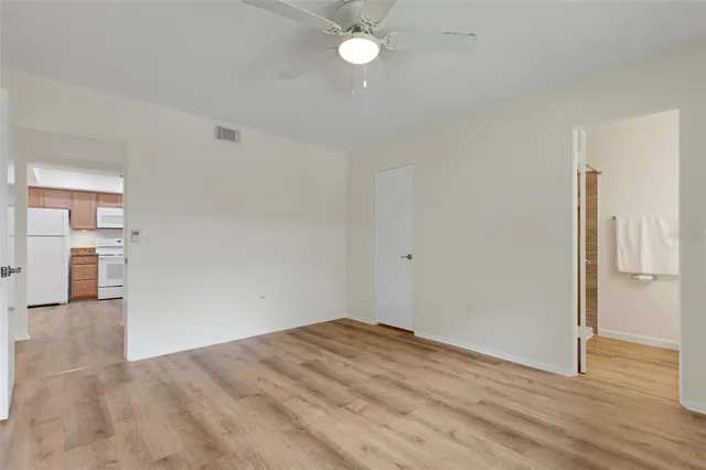 a view of empty room with wooden floor
