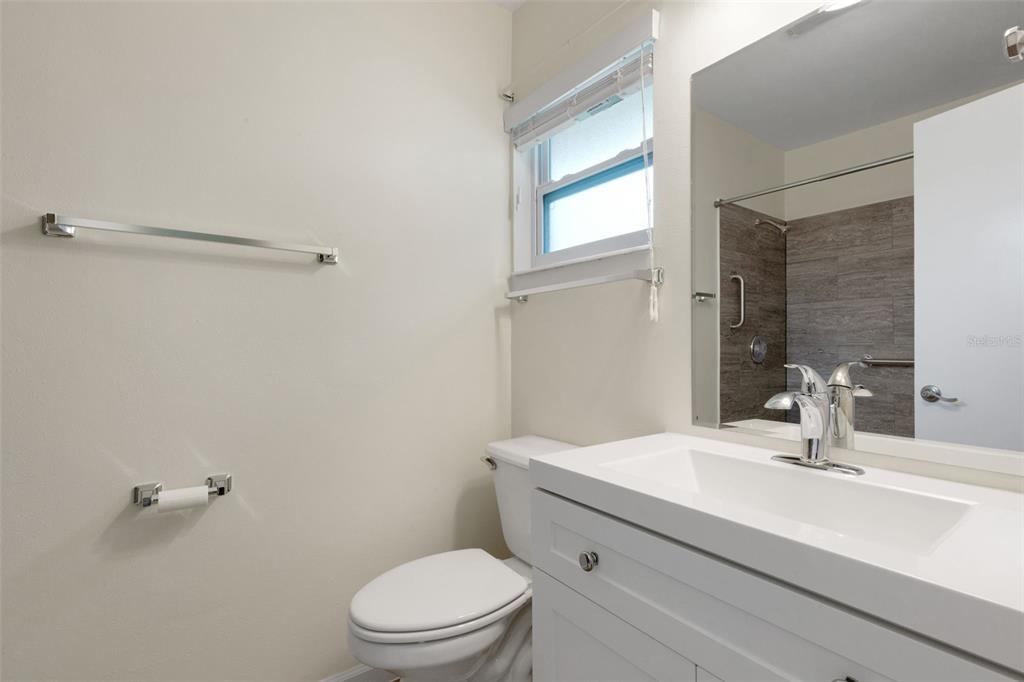 66 Strathmore Boulevard Sarasota, FL 34233 - Photo 20 of 39 a bathroom with a sink a toilet and shower