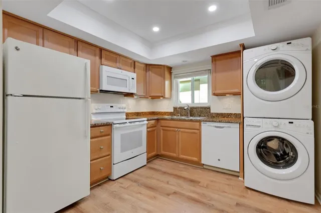 a kitchen with a refrigerator sink and cabinets