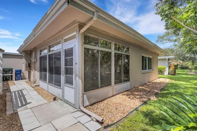a view of backyard with large trees and plants