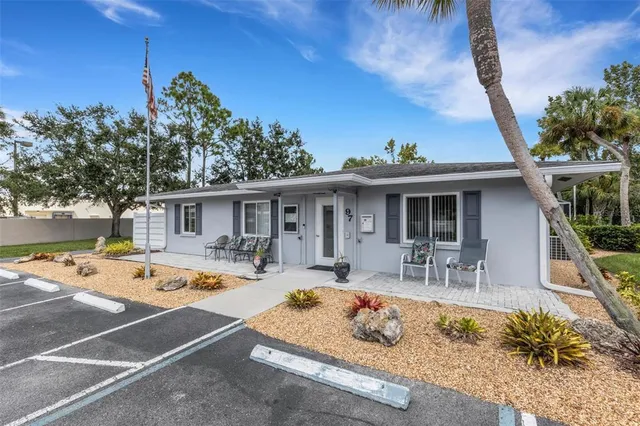a view of a house with backyard and sitting area