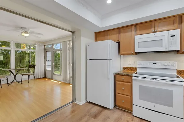 a kitchen with a refrigerator a stove top oven a sink and cabinets
