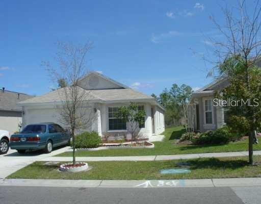 5704 Tanagerlake Road Lithia, FL 33547 - Photo 1 of 1 a front view of a house with a garden and trees