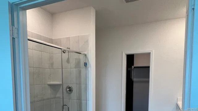 a bathroom with a glass door shower