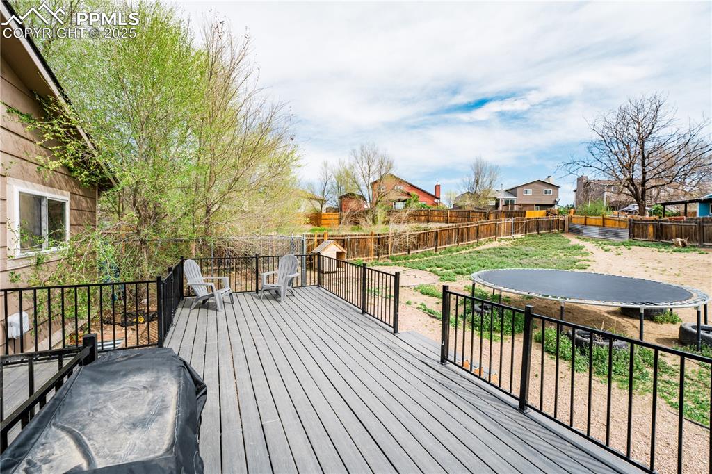 538 Blossom Field Road Fountain, CO 80817 - Photo 11 of 16 a view of a deck with table and chairs with wooden floor and fence