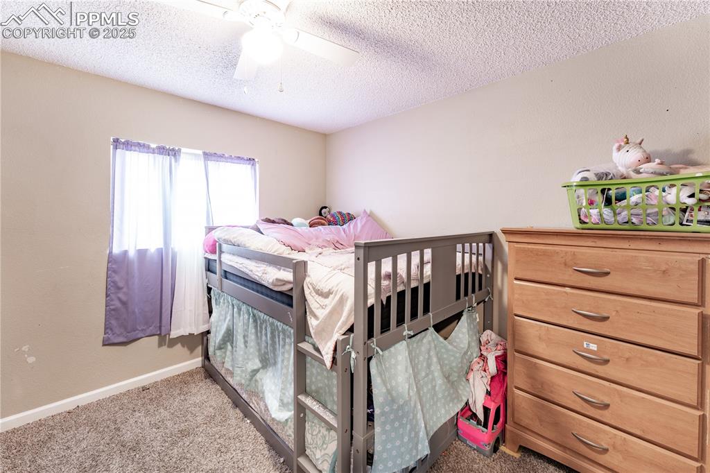 538 Blossom Field Road Fountain, CO 80817 - Photo 8 of 16 a bedroom with furniture and a window