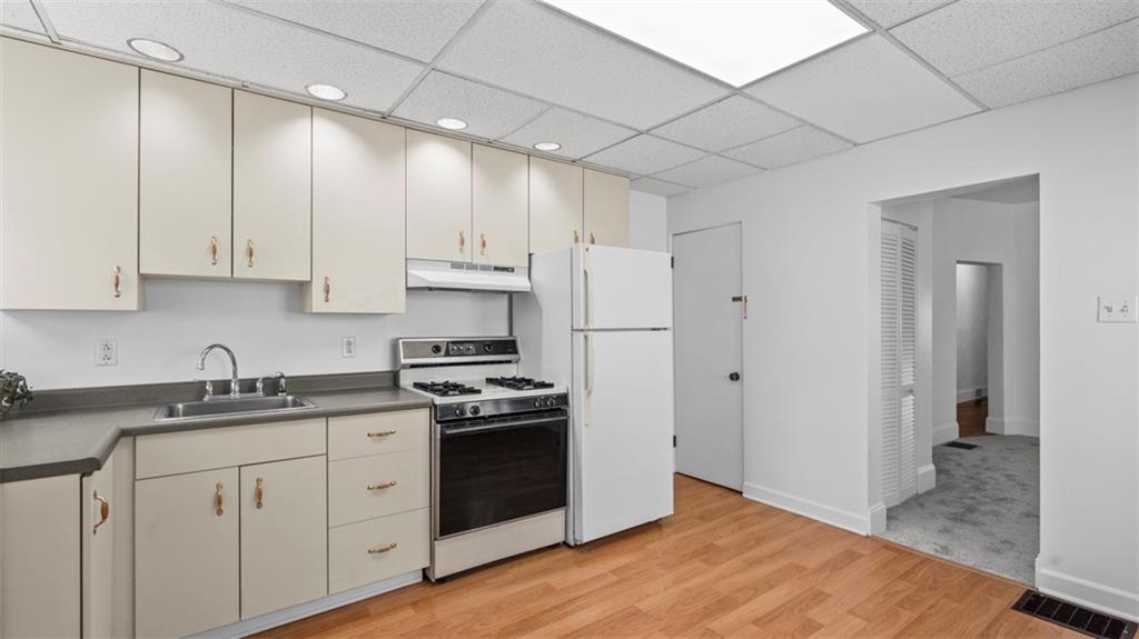 210 19th Street Pittsburgh, PA 15215 - Photo 14 of 33 a kitchen with stainless steel appliances granite countertop a sink stove and refrigerator