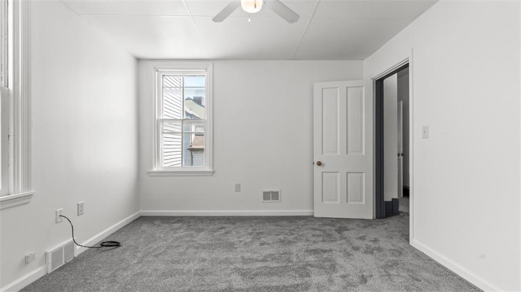 210 19th Street Pittsburgh, PA 15215 - Photo 23 of 33 a view of an empty room with window and chandelier fan