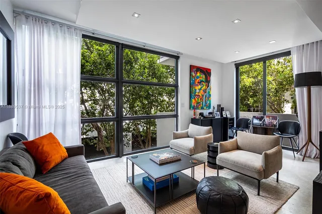 a living room with furniture and a large window