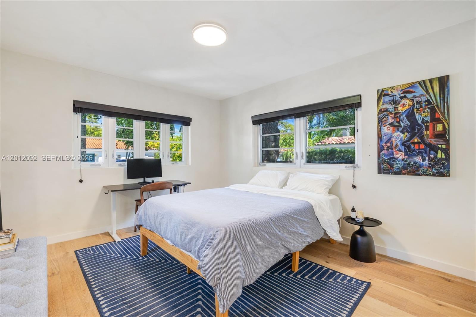 830 Northeast 72nd Street Miami, FL 33138 - Photo 11 of 19 a bed room with a bed and a window